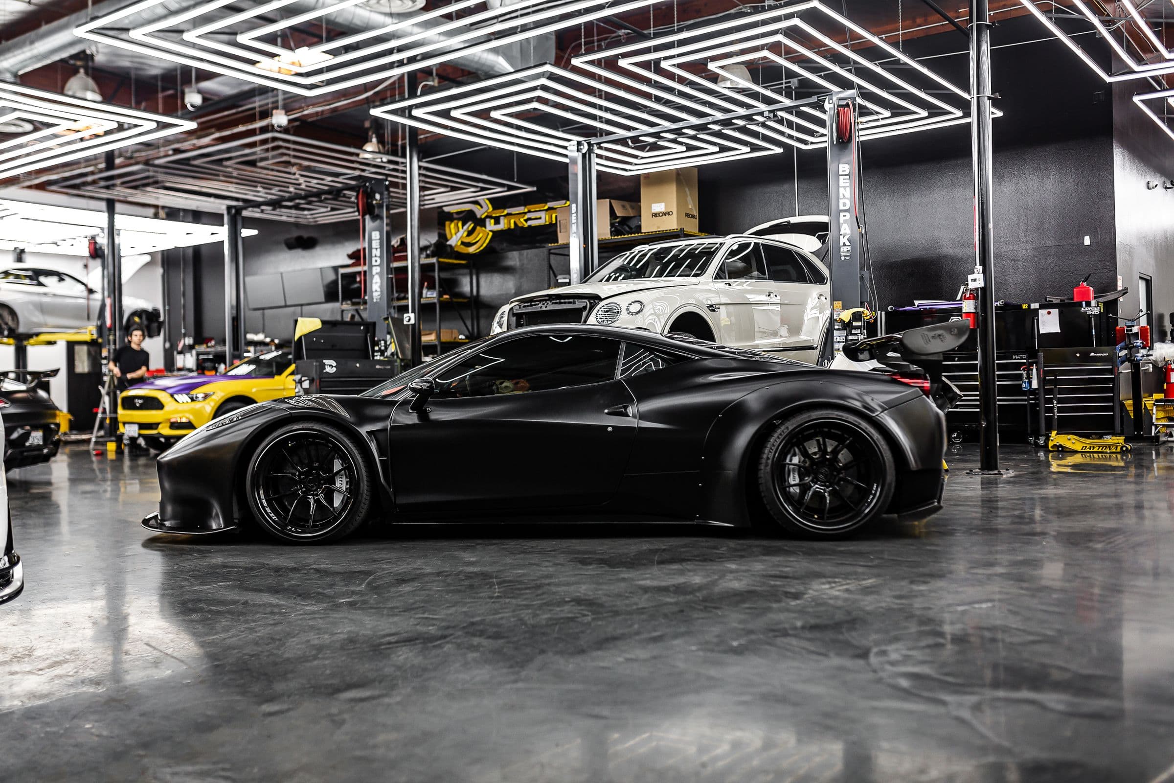 The interior of an automotive workshop, vehicles under service
